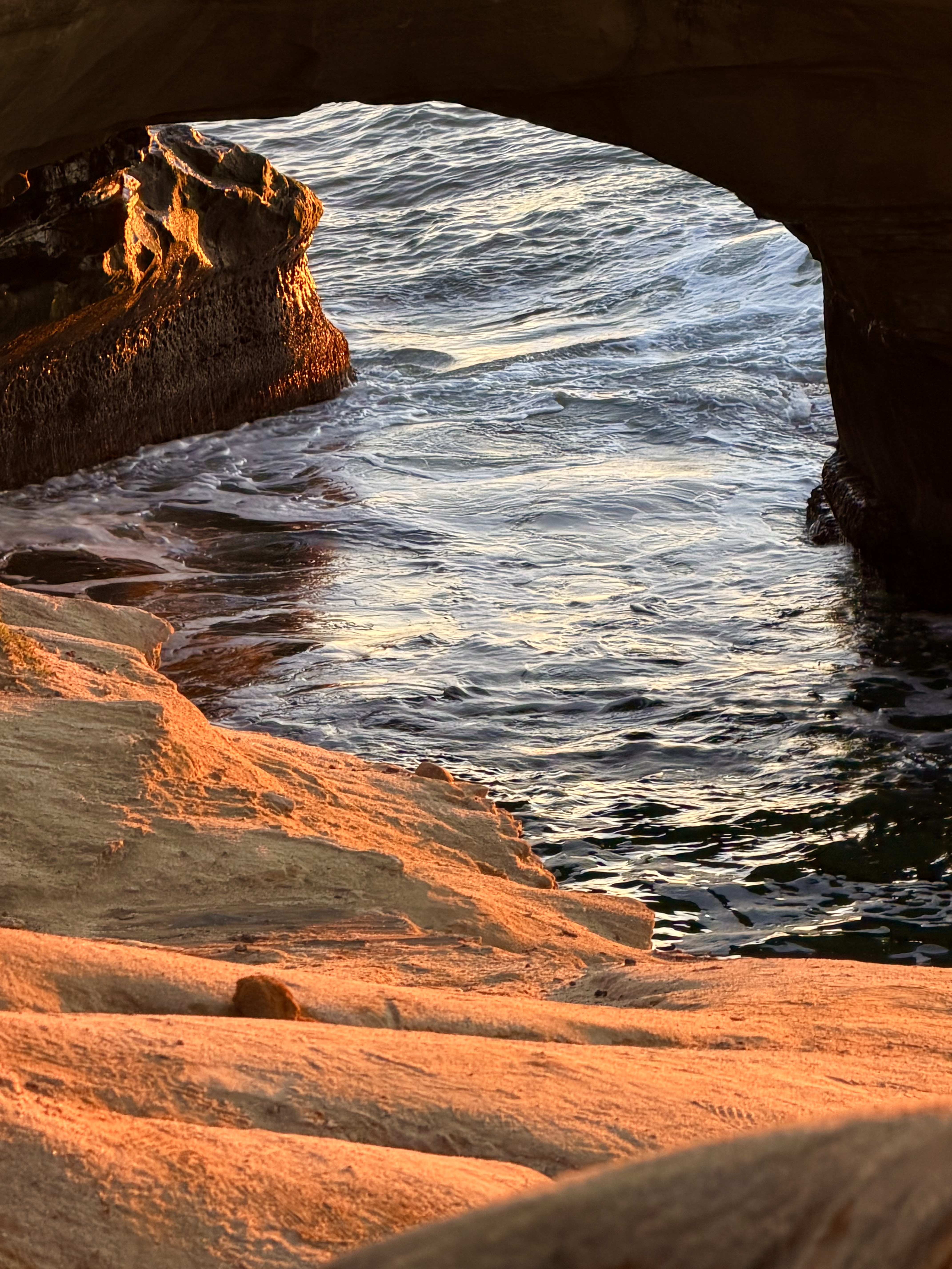 Sunlit sea cave opening onto the Pacific along the Southern California coast